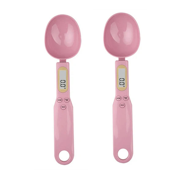 Two pink digital measuring spoon scales with LCD displays, shown side by side on a white background