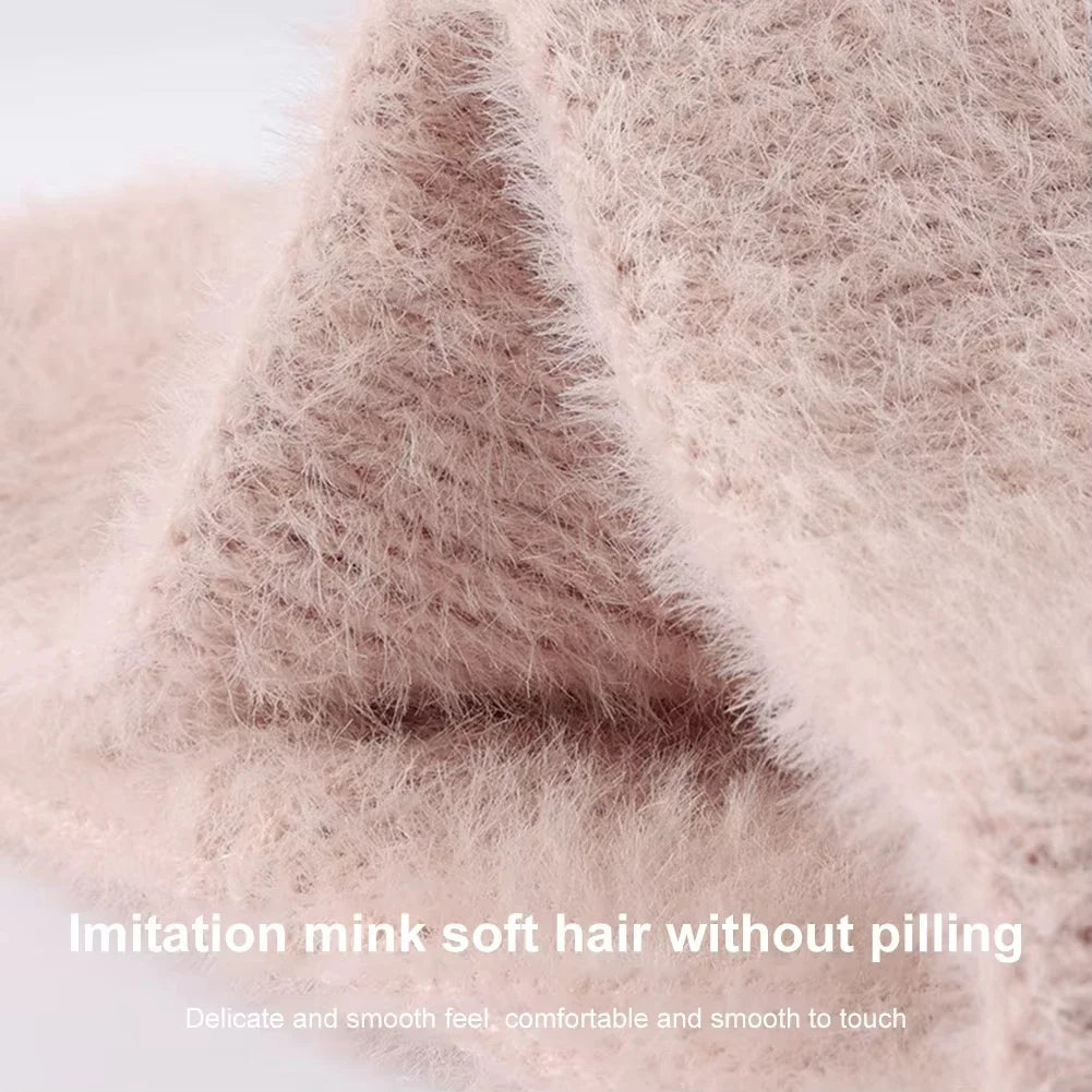 Close-up of a light pink, fluffy knit winter ear warmer headband showing its soft texture