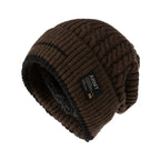 Brown cable knit beanie with black inner lining and patch detail, shown on a white background