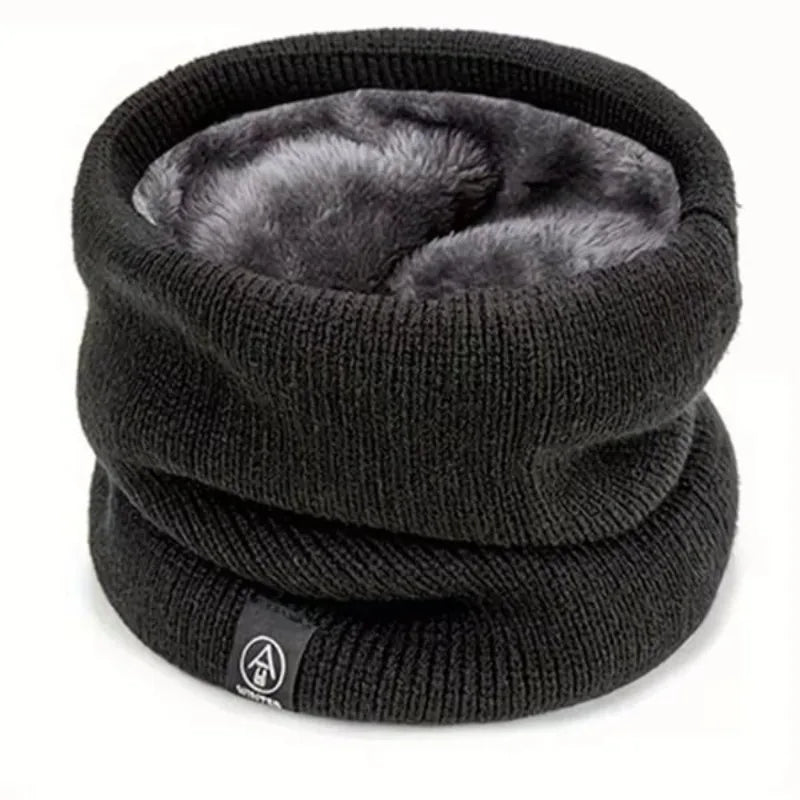 Thick dark grey knitted neck warmer with a soft grey faux fur lining, shown on a white background