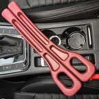 Pair of red car seat gap fillers resting across a black car center console with cup holders