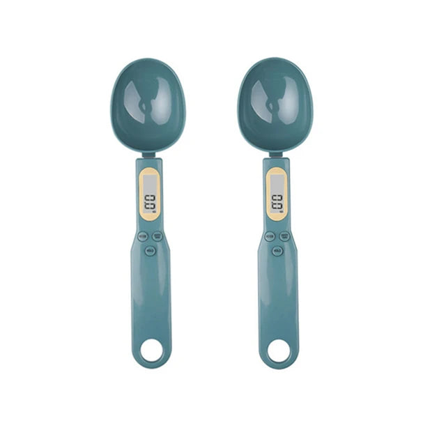 Two teal digital measuring spoons with small LCD screens on the handles, shown side by side