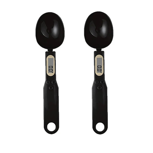 Two black digital measuring spoon scales with small display screens, shown side by side on white background