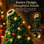 Green Christmas tree-shaped ceiling projector with red ornaments and warm yellow LED lights, close-up