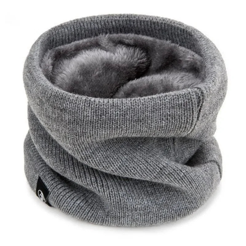 Grey knitted neck warmer with soft, plush lining, shown standing upright on a white background