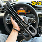Two black foam car seat gap fillers held in a hand inside a car, with the steering wheel visible