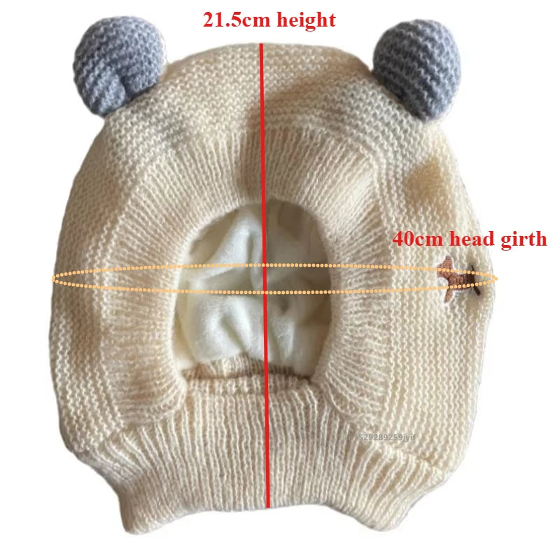 Cream-colored knitted dog ear muffs with gray ear details, laid flat, size measurements shown