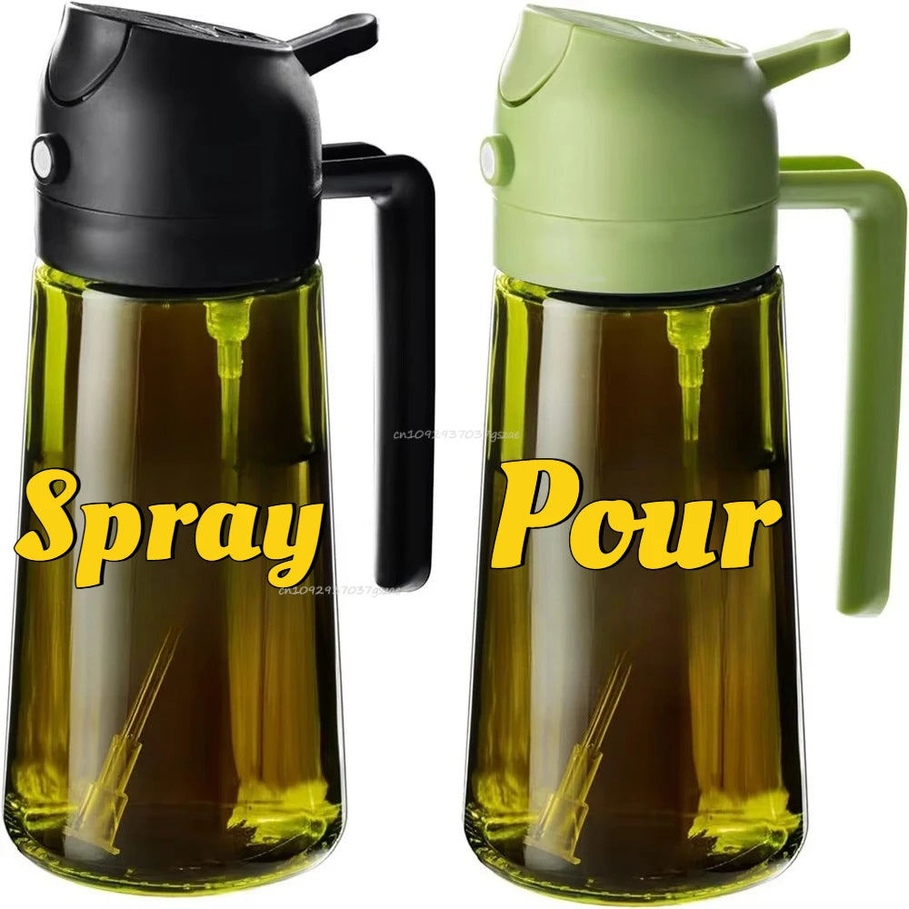 Two clear oil bottles side by side, one with a black lid and one with a green lid, both with handles