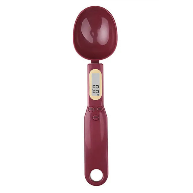 Burgundy digital measuring spoon with LCD display, shown from above on a white background