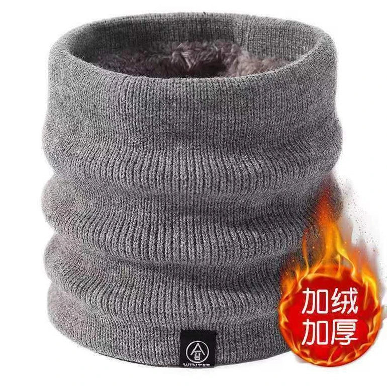 Gray knitted neck warmer standing upright, fuzzy lining visible inside, flame graphic on the side