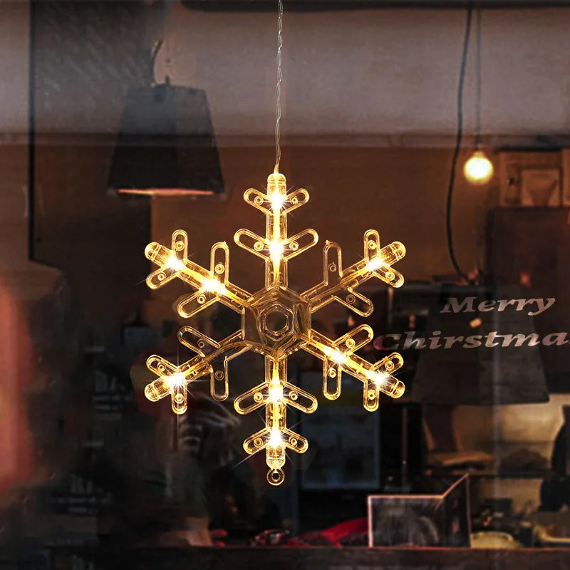Warm white LED snowflake ornament hanging in a window with a cozy indoor background