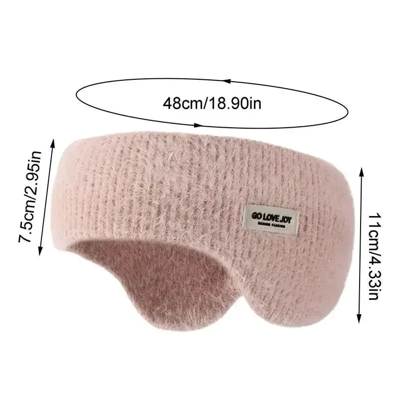 Light pink fuzzy ear warmer headband with size measurements in centimeters and inches, close-up view