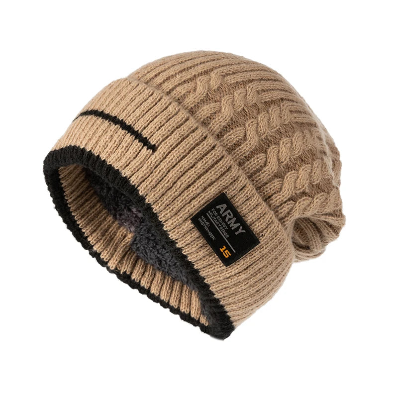Tan cable knit beanie with black trim and patch, shown close-up on a white background