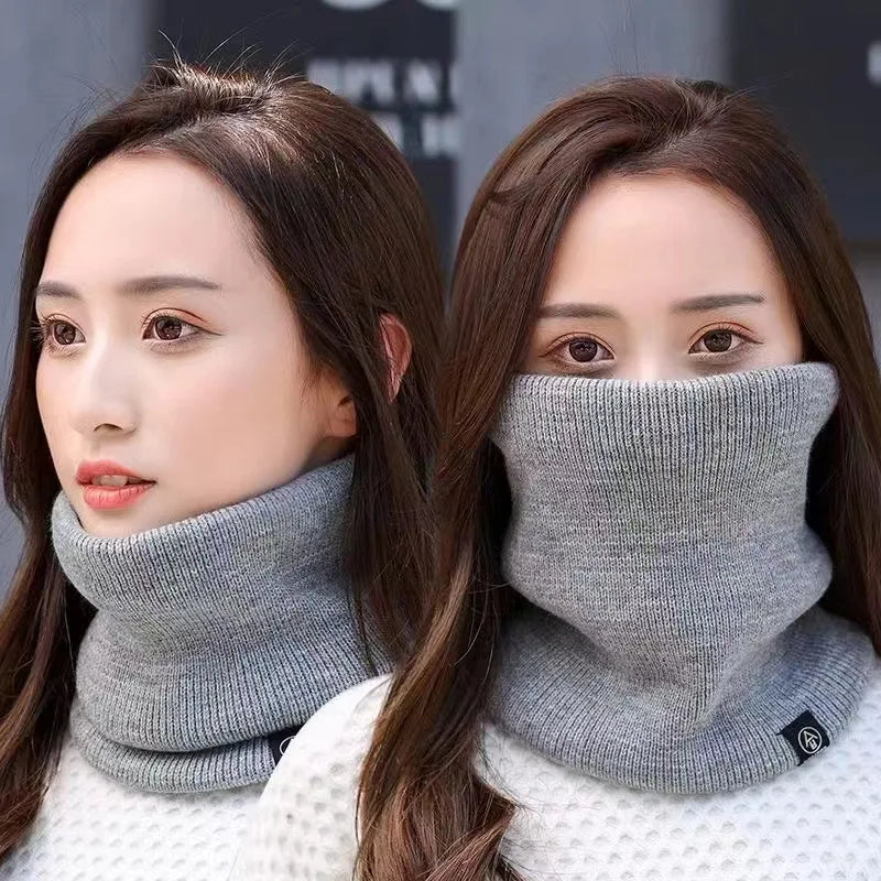 Two women wearing light grey knitted neck warmers, one with it covering the neck and one over the face