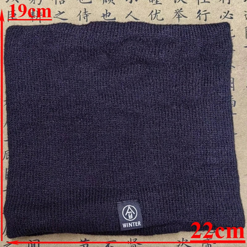 Black knitted neck warmer with a small winter label, laid flat showing 19cm by 22cm dimensions