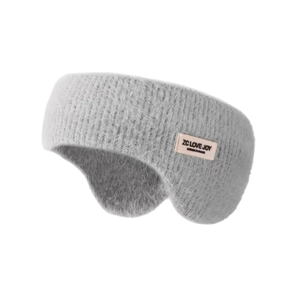 Light grey knit winter ear warmer headband with a small sewn tag, shown against a white background