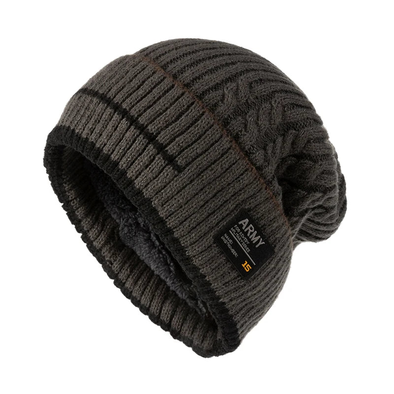 Dark gray cable knit winter beanie with a black fleece lining and a small fabric tag, side view
