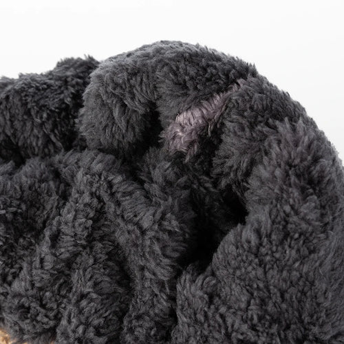 Close-up of the plush, dark grey faux fur lining inside a beanie, shown against a white background