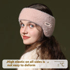 Young woman wearing a light pink, fuzzy knit ear warmer headband, side view against a dark background