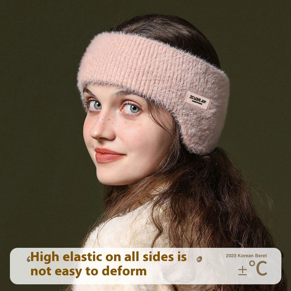 Young woman wearing a light pink, fuzzy knit ear warmer headband, side view against a dark background