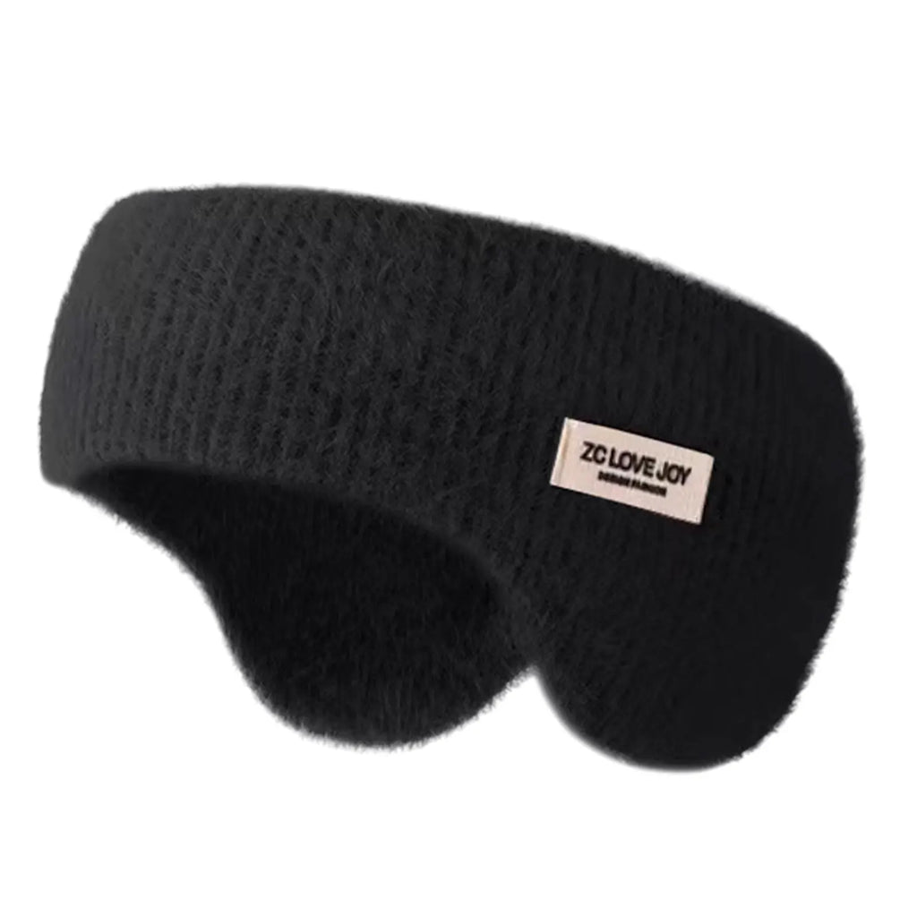 Black knitted winter ear warmer headband with a small beige tag, shown on a plain white background