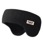 Black knitted winter ear warmer headband with a small beige tag, shown on a plain white background