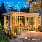 Warm white curtain string lights hanging on a white outdoor pergola with patio furniture at dusk