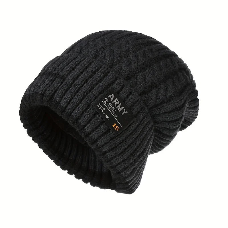 Thick black cable knit beanie with a ribbed cuff and a small patch on the front, shown on white