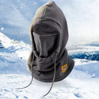 Gray fleece winter hood with drawstrings and face cover, shown on a snowy mountain background