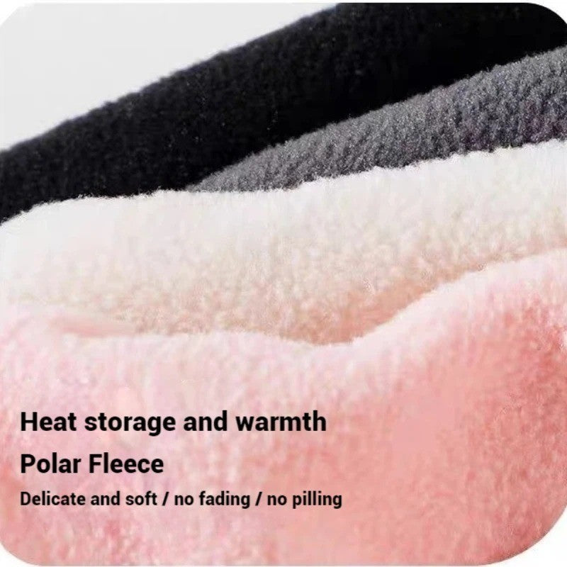 Close-up of four polar fleece fabrics in black, grey, off-white, and pink, stacked in layers