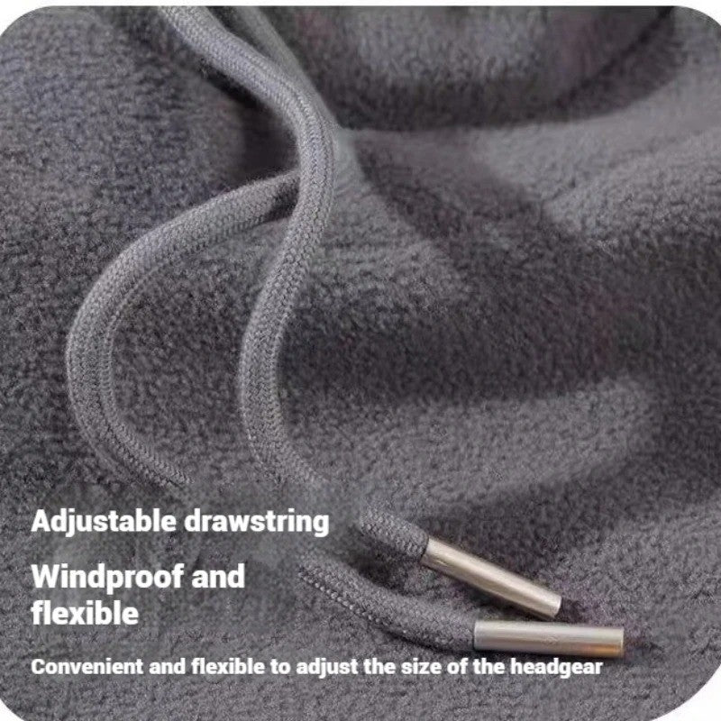 Close-up of a grey fleece fabric with an adjustable drawstring and metal cord ends, text overlayed