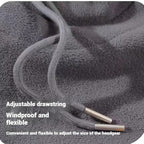 Close-up of a grey fleece fabric with an adjustable drawstring and metal cord ends, text overlayed