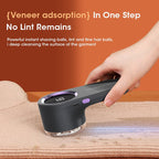 Hand using a black rechargeable lint remover with LED display on a beige knit sweater, close-up view