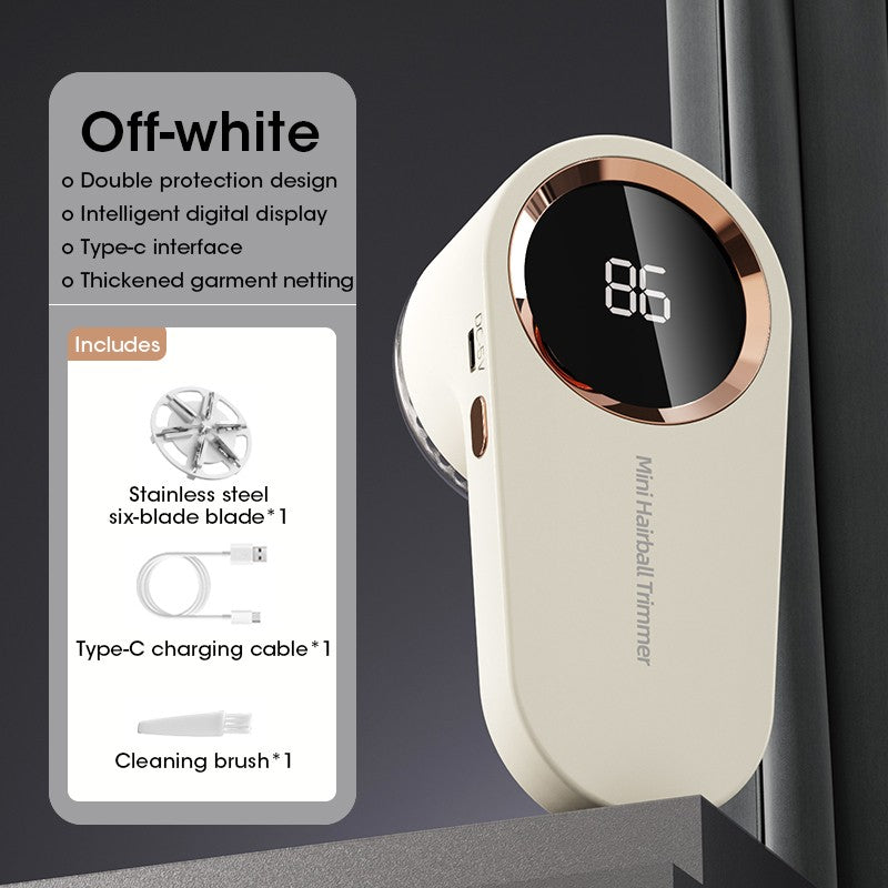 Off-white rechargeable lint remover with LED display, shown upright on a surface near a dark curtain